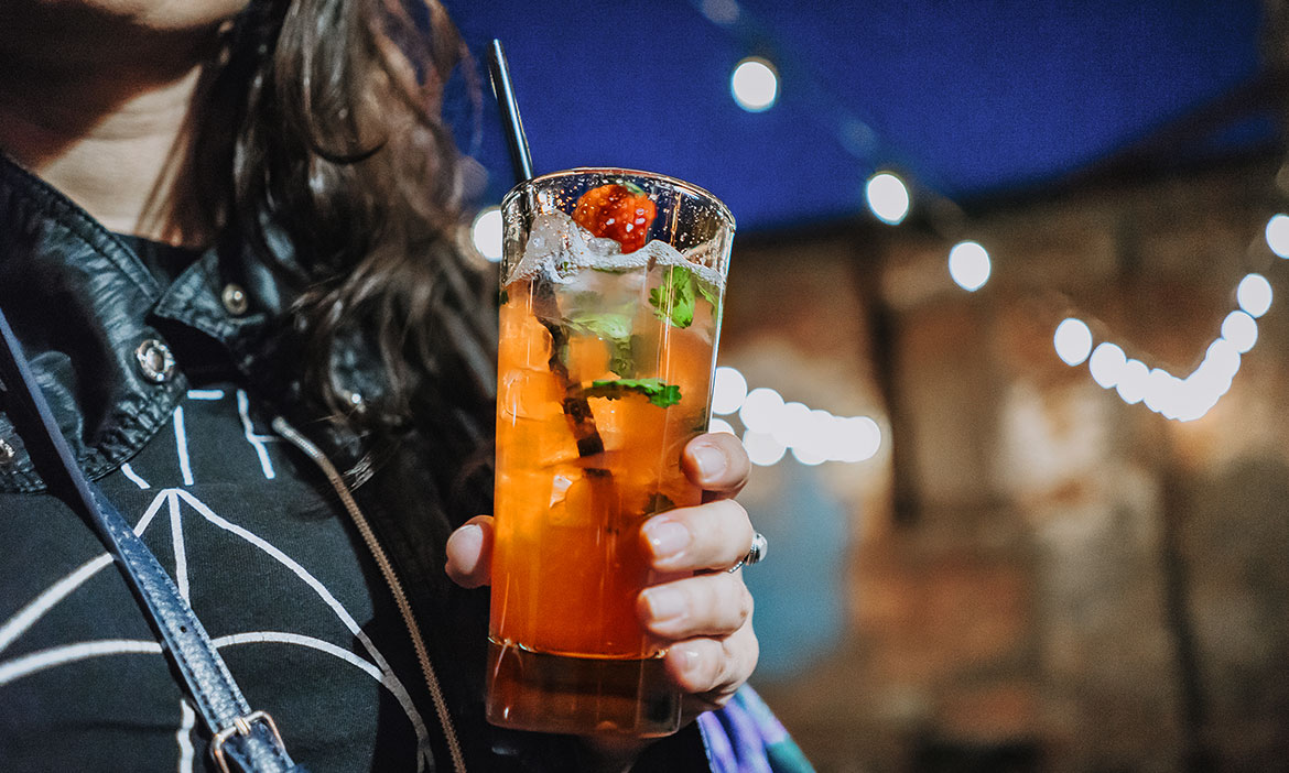 Girl holding a drink at ADCo Bar & Bottle Shop