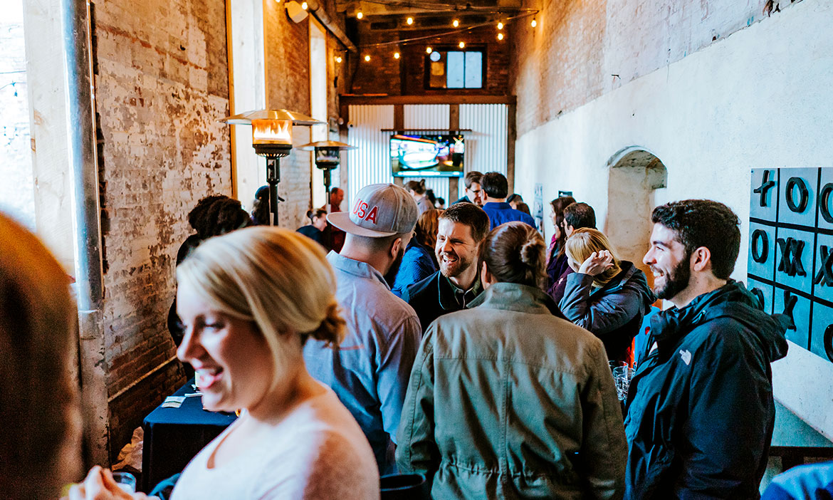 People socializing on the ADCo Bar & Bottle Shop patrio