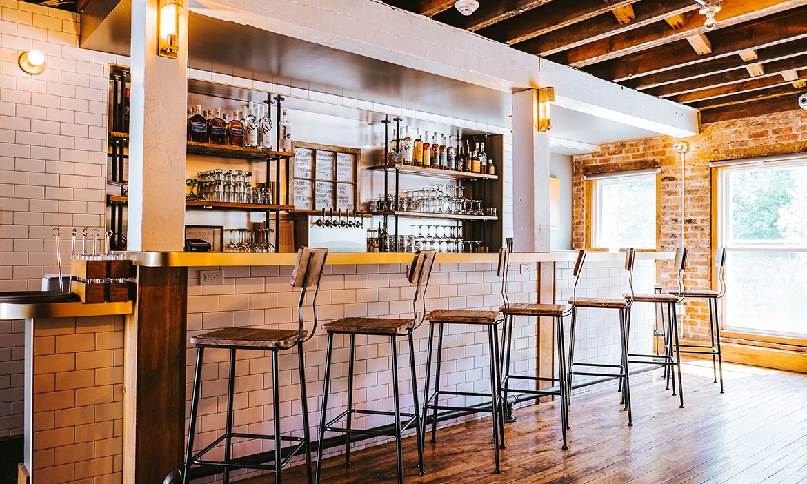 Empty chairs at ADCo Bar & Bottle Shop