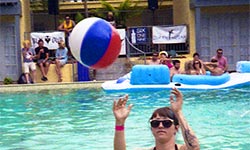 Ladies throwing a beach ball at pool party